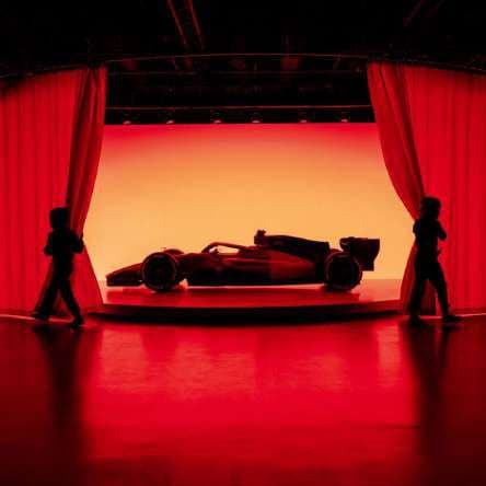 Show car in a red-lit room